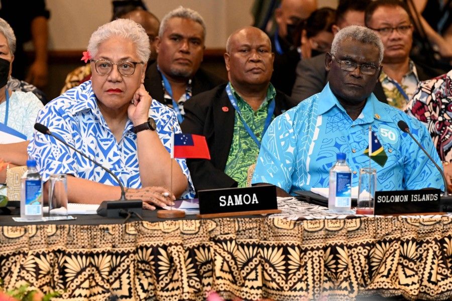 Samoa Prime Minister Fiamē Naomi Mataʻafa (left) and Solomon Islands Prime Minister Manasseh Sogavare (right) listen to the opening remarks of the Pacific Islands Forum (PIF) in Suva on 12 July 2022. (William West/AFP)