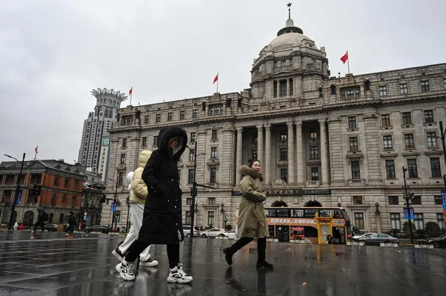 People walk past a bank in Shanghai on 19 January 2026.
