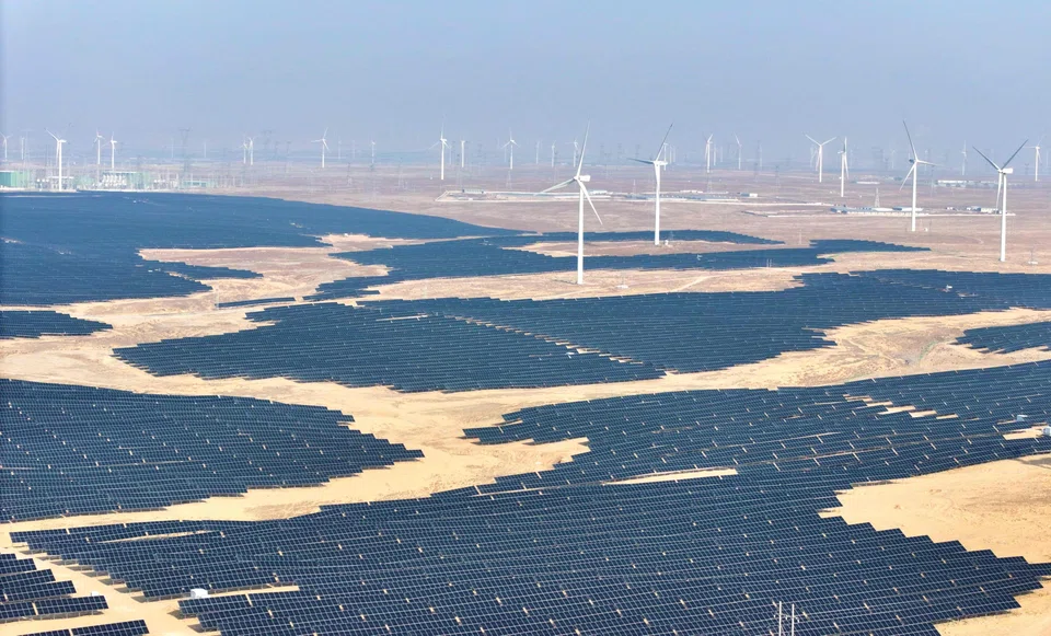 This picture taken on 22 December 2025 shows solar panels and wind turbines at a renewable energy farm in Lingwu, Ningxia region, China. (AFP)