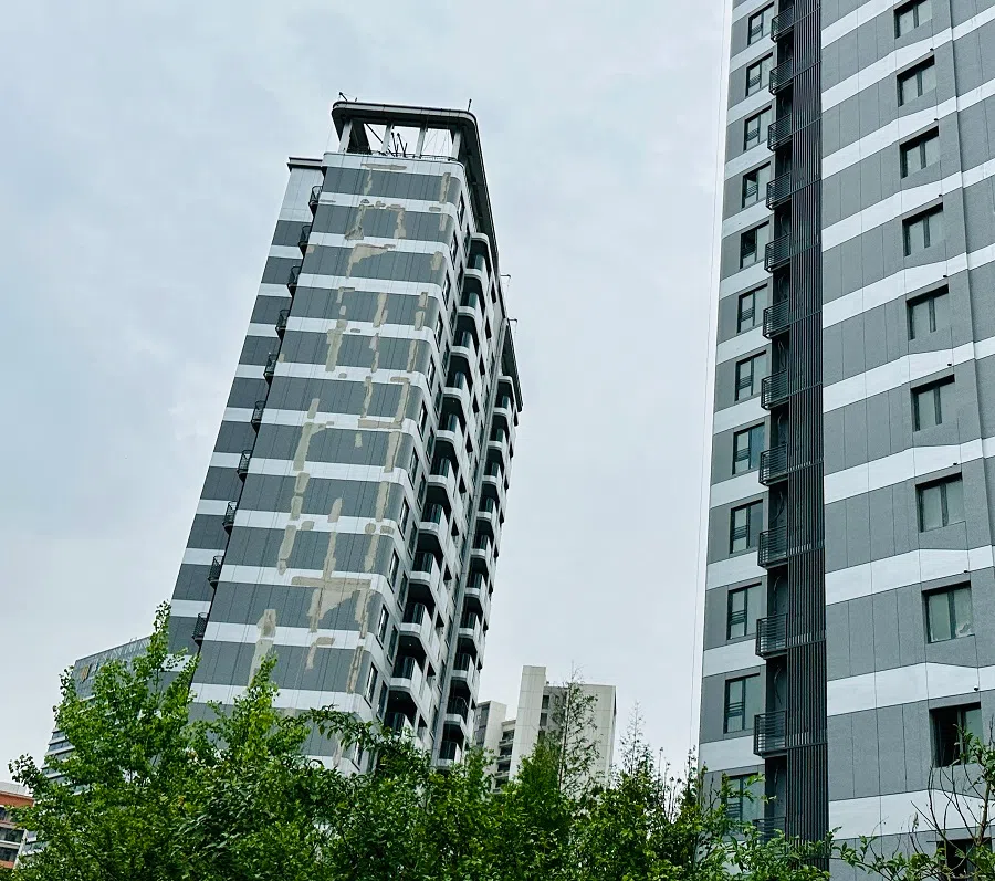 A sections of paint on the exterior walls of residential buildings in the Lin-gang Jiuhai Yuntian residential development have peeled off, June 2024. (SPH Media)