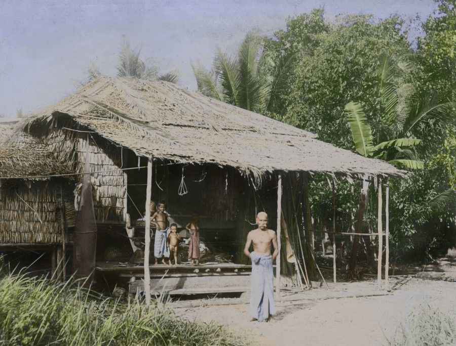 An Indian family living in a straw house beside the Kallang River. Apart from Chinese coolies, there were also Indian coolies who came to Singapore, who worked in plantations, factories, and trading ports.