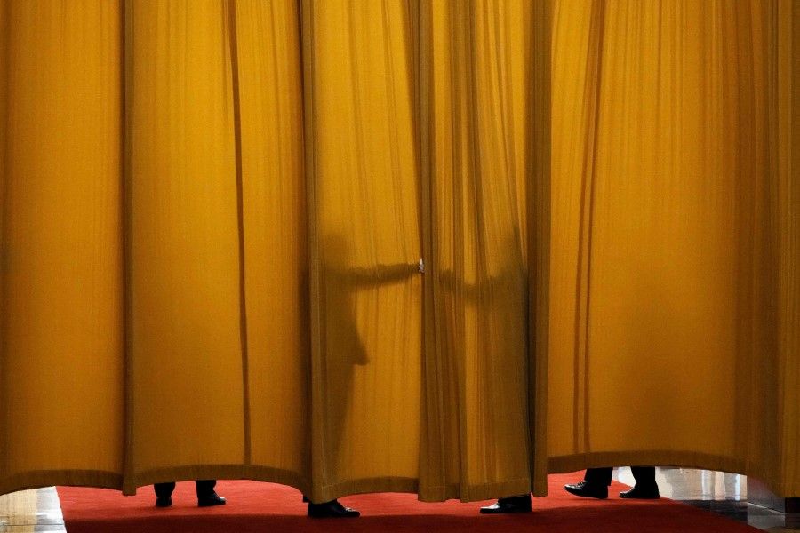 Guards keep a curtain closed at the Great Hall of the People in Beijing on 6 April 2023. (Thibault Camus/AFP)