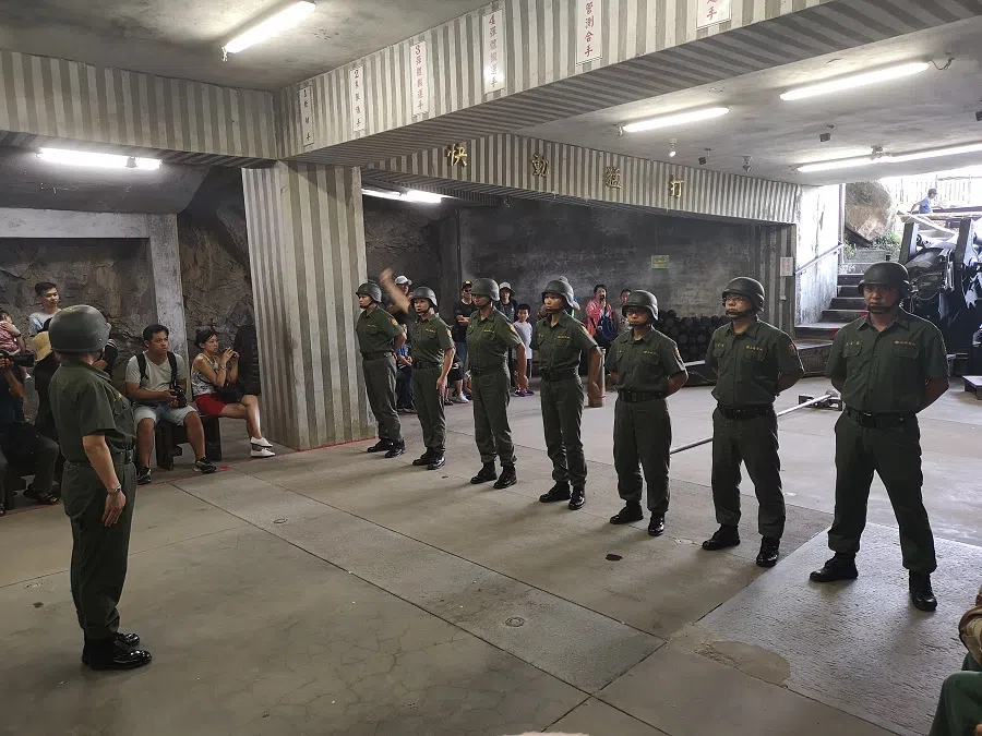 Soldiers march out and operate a cannon up close for tourists.