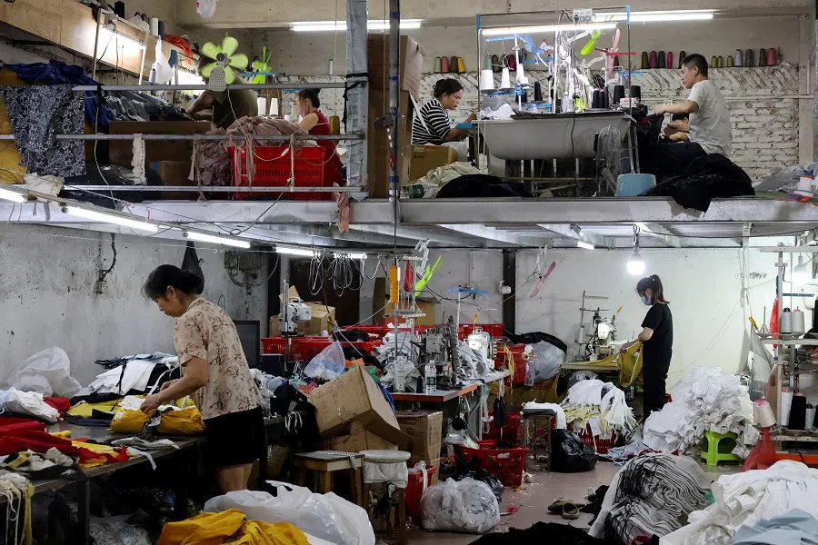 People work in a textile factory in Panyu district, Guangzhou, Guangdong province, China, on 10 May 2025. (Go Nakamura/Reuters)