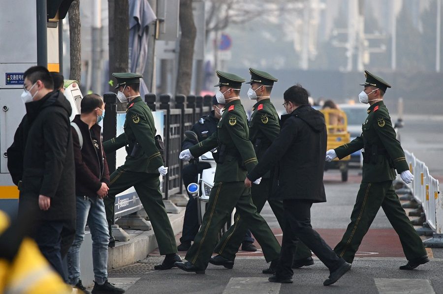 Paramilitary police officers march at the south end of Tiananmen Square in Beijing, China, on 5 March 2023. (Greg Baker/AFP)