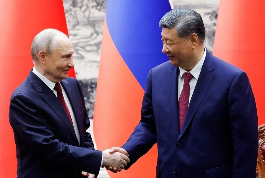 Russian President Vladimir Putin and Chinese President Xi Jinping shake hands during a signing ceremony at the Great Hall of the People in Beijing, China, 20 May 2026.