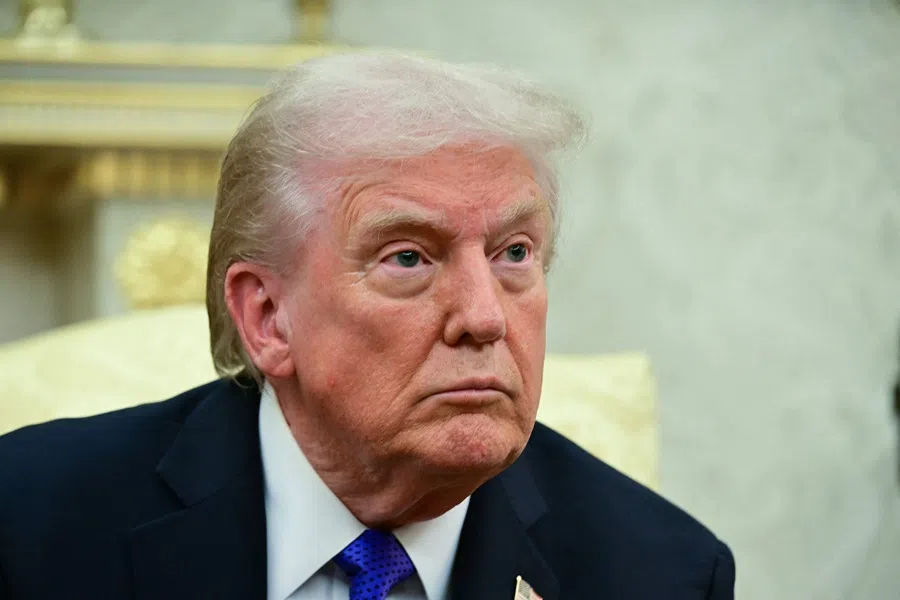 US President Donald Trump looks on during a meeting in the Oval Office of the White House in Washington, DC, on 22 October 2025.