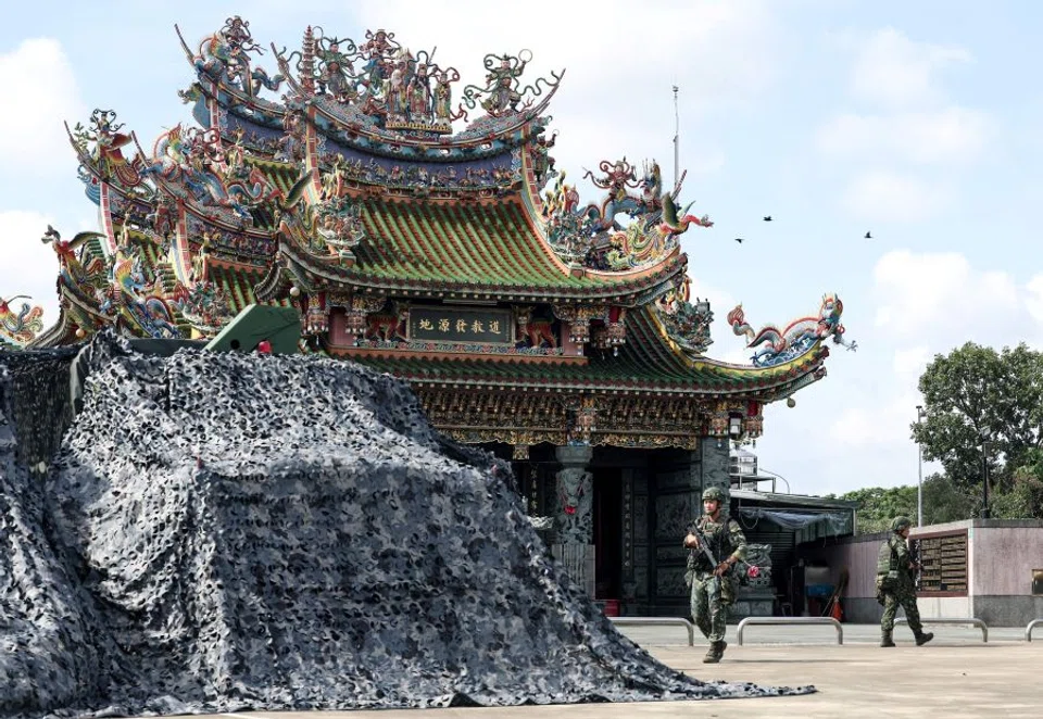 A covered Taiwanese military truck and a camp are seen at a local temple during the annual Han Kuang exercises in Tainan on 14 July 2025. (I-Hwa Cheng/AFP)