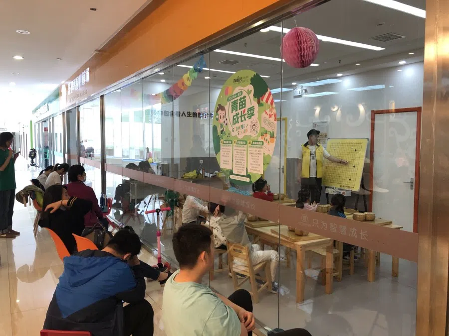 Golden Resources Shopping Mall in Beijing offers all sorts of classes for children. In this photo, parents congregate outside a centre while their children take go classes inside.