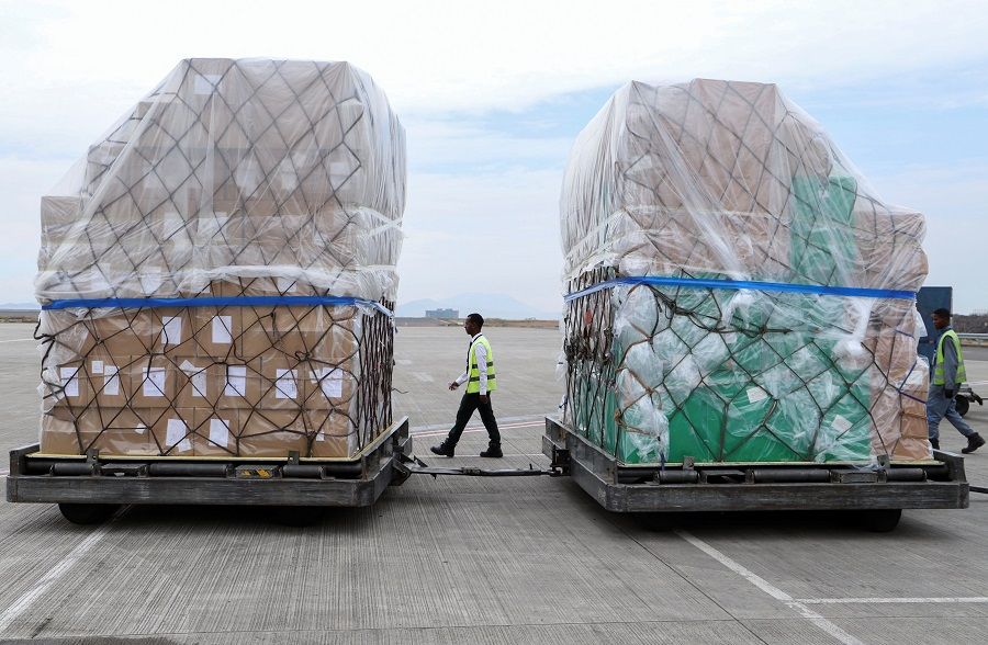Ethiopian Airlines workers unload a consignment of medical donation from Chinese billionaire Jack Ma and Alibaba Foundation to Africa for Covid-19 testing, upon arrival at the Bole International Airport in Addis Ababa, Ethiopia, on 22 March 2020. (Tiksa Negeri/Reuters)