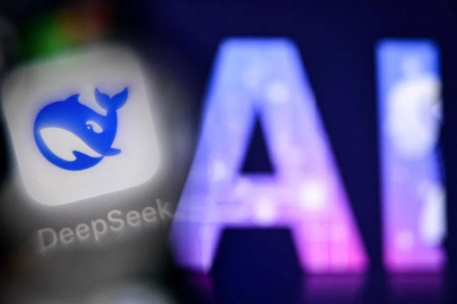 This photo taken on 1 September 2025 shows the letters AI for Artificial Intelligence on a laptop screen next to the logo of the Deepseek AI application on a smartphone screen in Frankfurt am Main, Germany.
