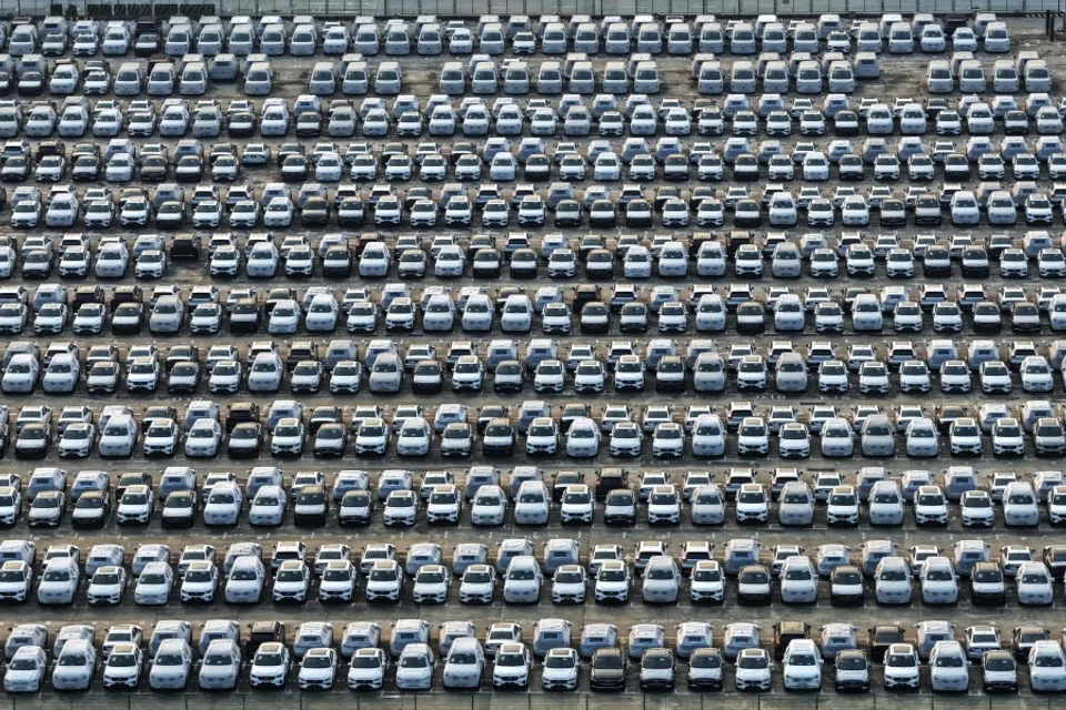 An aerial view shows Chinese-made cars parked at a port in Nanjing, in China’s eastern Jiangsu province, on 11 July 2025, before being loaded onto a ship for export. (AFP)