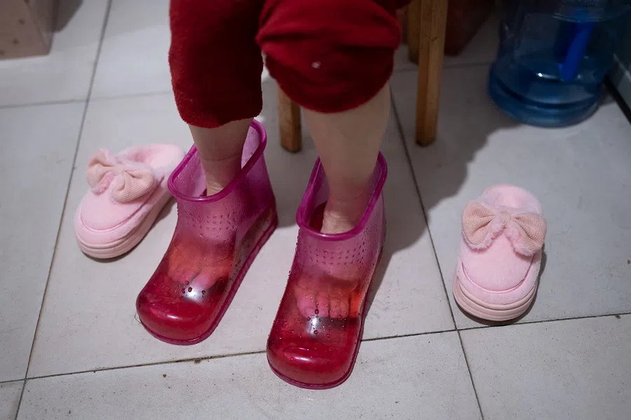Sister Chen bathes her feet at home on a winter’s day.