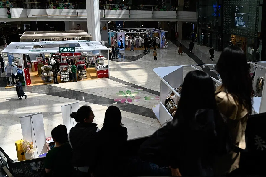 People are seen at a shopping mall in Beijing, China, on 14 April 2025. (Pedro Pardo/AFP)