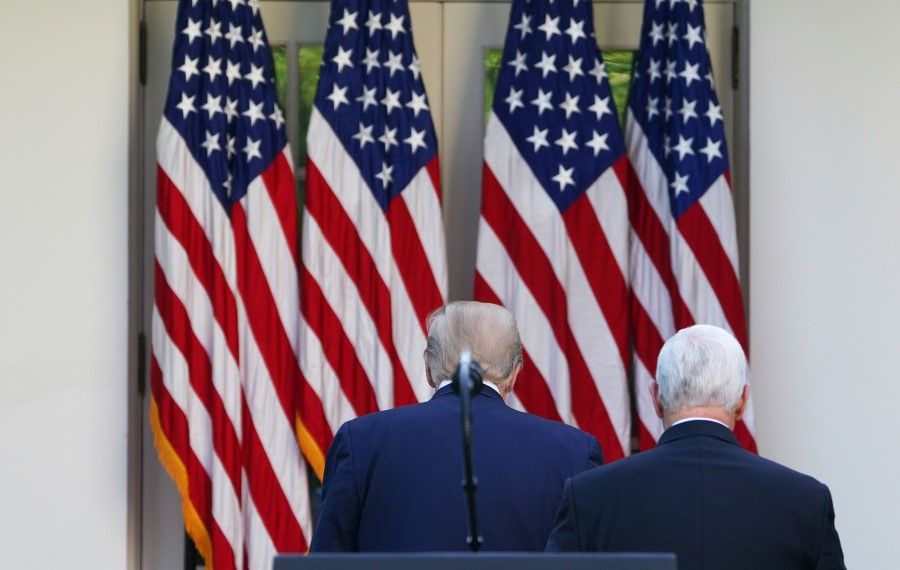 US President Donald Trump (L) and US Vice President Mike Pence return to the Oval Office after a press conference on the coronavirus at the White House in Washington, DC, April 27, 2020. (Mandel Ngan/AFP)
