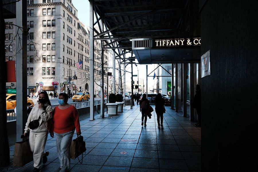 People walk by retail stores in Manhattan on 6 April 2021 in New York City, US. (Spencer Platt/Getty Images/AFP)