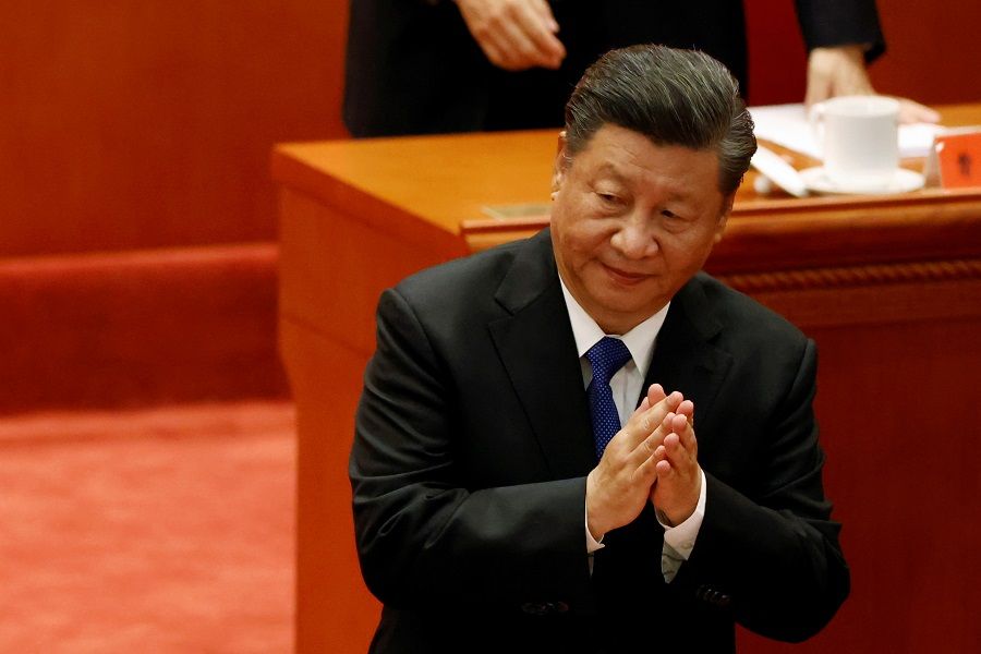 Chinese President Xi Jinping applauds at a meeting commemorating the 110th anniversary of Xinhai Revolution at the Great Hall of the People in Beijing, China, 9 October 2021. (Carlos Garcia Rawlins/Reuters)