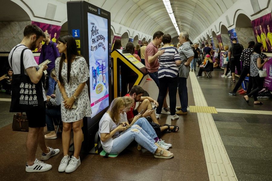 People take cover inside a subway station during an air raid alert, amid the Russia-Ukraine war, in Kyiv, Ukraine, on 26 July 2023. (Alina Smutko/Reuters)