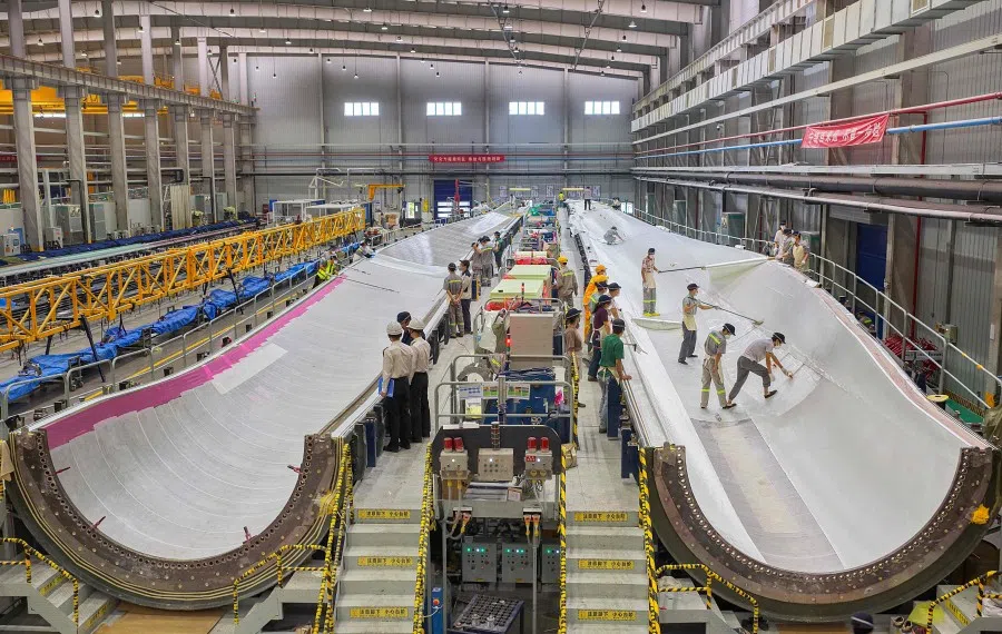 Employees work on wind turbine blades at a wind power company in Nantong in eastern China’s Jiangsu province on 26 October 2025.