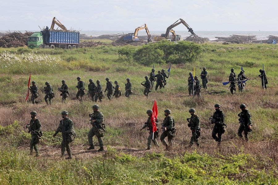 Soldiers walk back to base after an anti-invasion formation practice on the beach during the annual Han Kuang military drill in Tainan, Taiwan, 14 September 2021. (Ann Wang/Reuters)