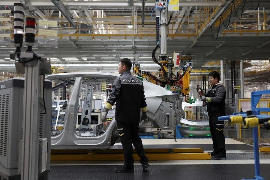 Employees work on an electric vehicle (EV) production line at the Volkswagen Anhui factory in Hefei, Anhui province, China, on 4 February 2026.