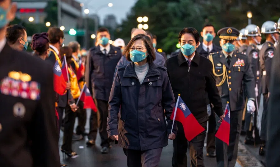 Taiwan President Tsai Ing-wen (left) and Vice-President William Lai (right, in back) attend a New Year flag-raising ceremony outside the Presidential Office Building in Taipei, Taiwan, in this Taiwan Presidential Office handout released 1 January 2023. (Taiwan Presidential Office/Handout via Reuters)