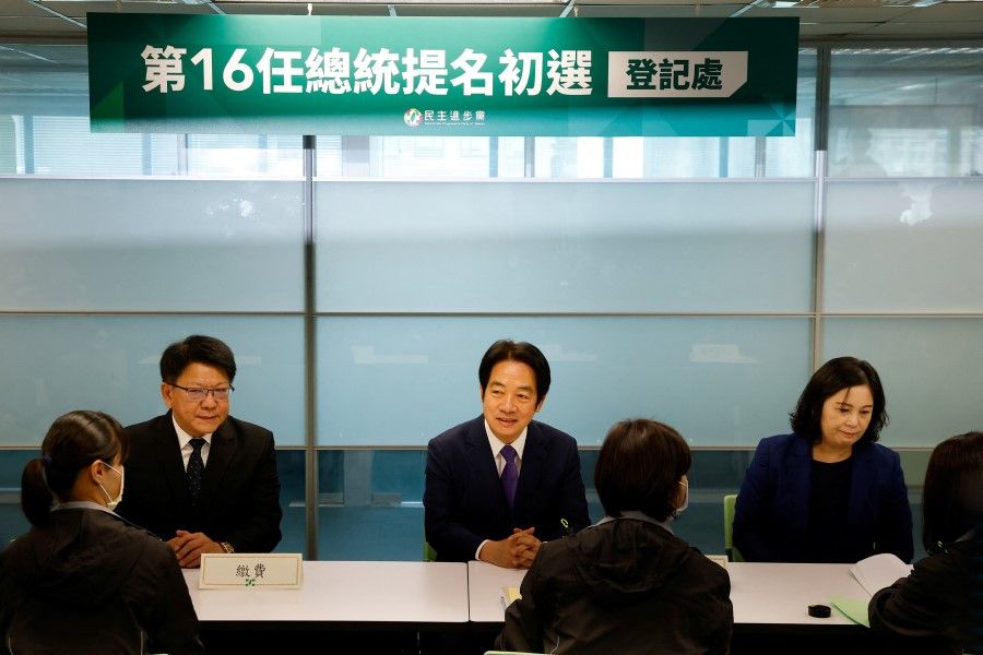 Taiwan's Vice-President William Lai (centre) arrives to register as the presidential candidate for the ruling Democratic Progressive Party (DPP) in Taipei, Taiwan, 15 March 2023. (Ann Wang/Reuters)