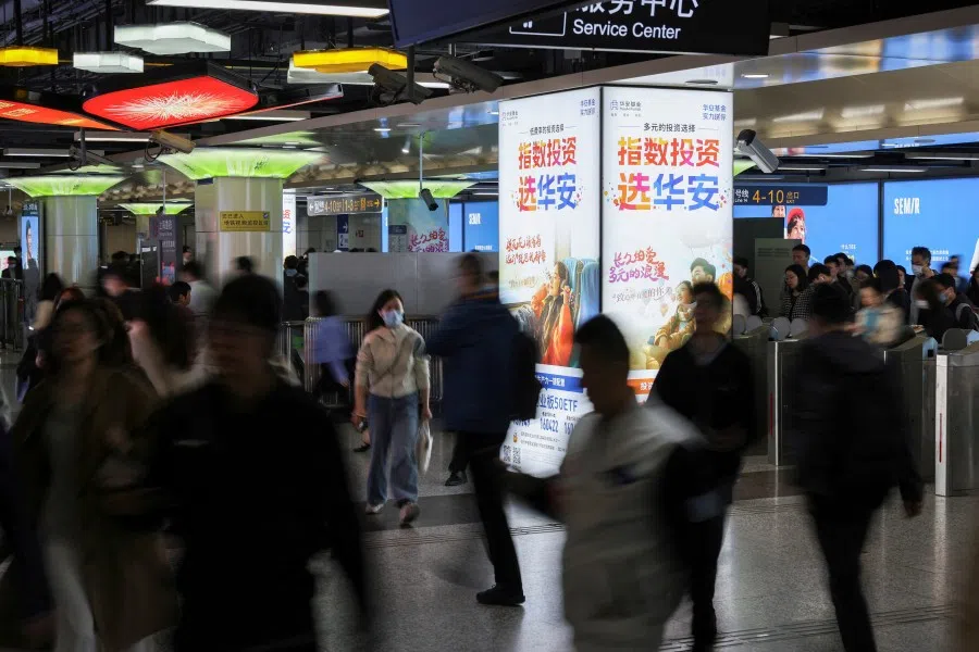 Commuters walk in a subway station at the Lujiazui financial district in Shanghai, China, on 15 April 2025. (Go Nakamura/Reuters)