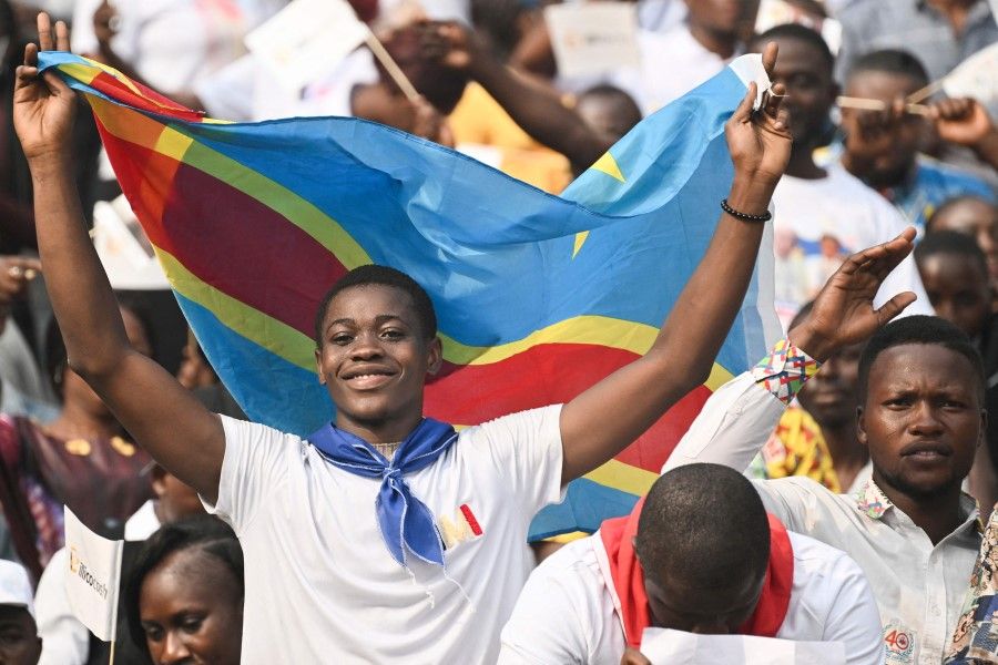 Congolese cheer ahead of Pope Francis's arrival at Martyrs' Stadium in Kinshasa, Democratic Republic of the Congo (DRC), on 2 February 2023. The competition between China and the US in the DRC is intensifying. (Tiziana Fabi/AFP)