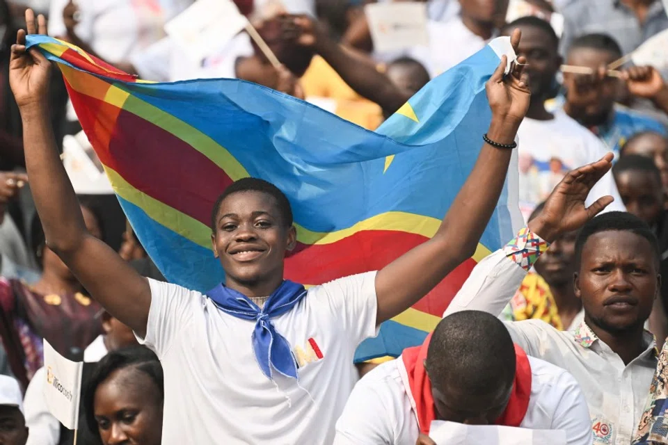 Congolese cheer ahead of Pope Francis's arrival at Martyrs' Stadium in Kinshasa, Democratic Republic of the Congo (DRC), on 2 February 2023. The competition between China and the US in the DRC is intensifying. (Tiziana Fabi/AFP)