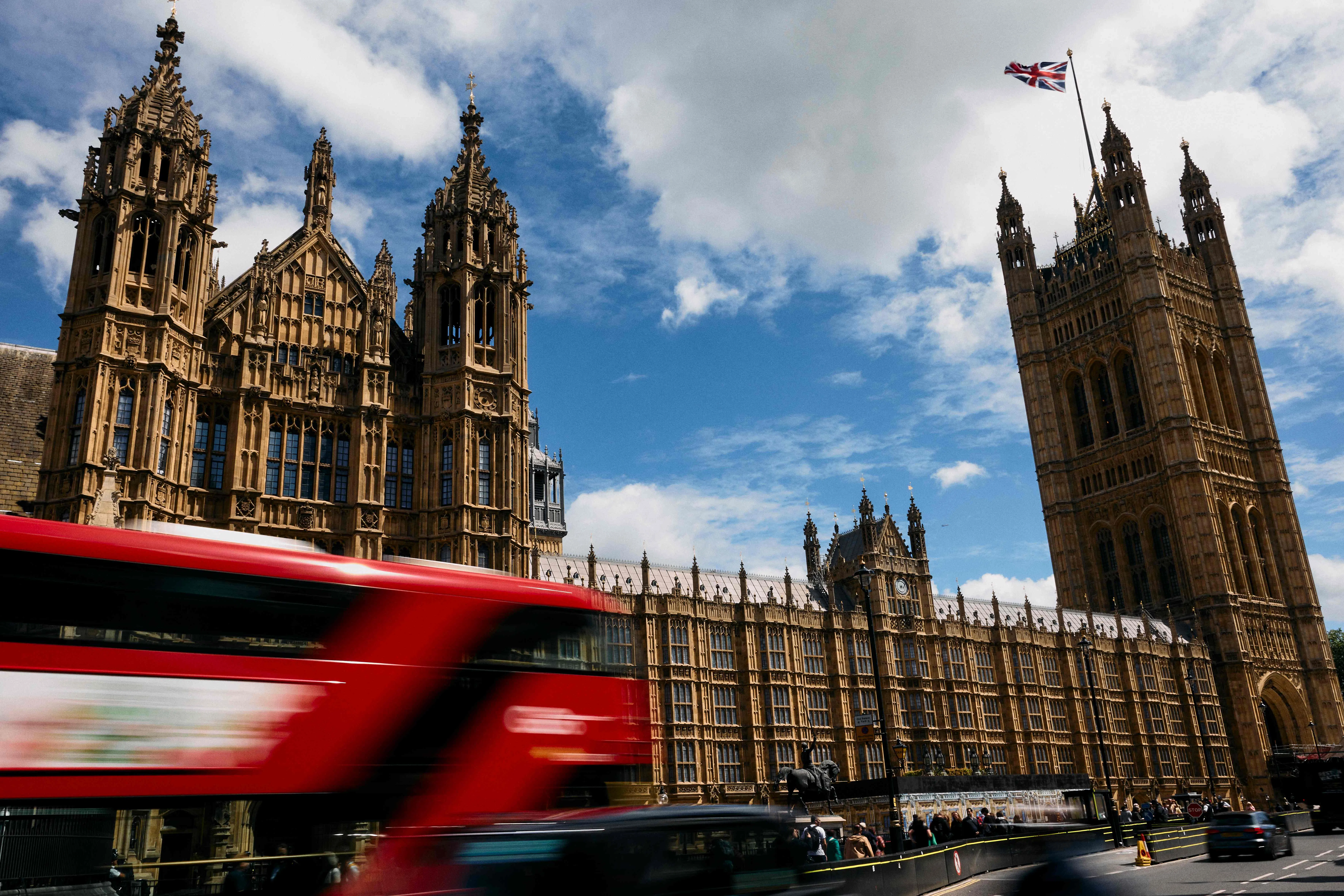 A London double decker bus goes past the Palace of Westminster, home to the Houses of Parliament, in central London, on 14 June 2024.  (Benjamin Cremel/AFP)