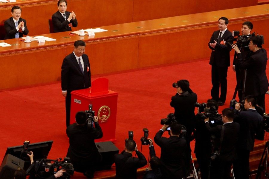 Chinese President Xi Jinping pauses after casting his ballot during a vote on a constitutional amendment lifting presidential term limits, at the third plenary session of the National People's Congress (NPC) at the Great Hall of the People in Beijing, China March 11, 2018. (Damir Sagolj/Reuters)