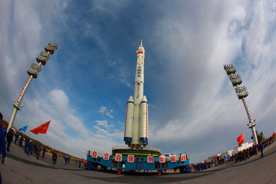 This photo taken on 7 October 2021 shows a Long March-2F carrier rocket, carrying the Shenzhou-13 spacecraft, being transported to the launching area at the Jiuquan Satellite Launch Centre in Gansu province, China. (STR/AFP)