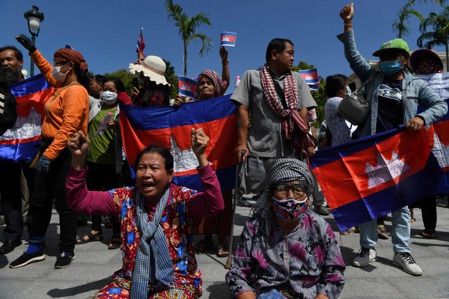 Protesters shout slogans during a protest to mark the 29th anniversary of the Paris Peace Accord in front of the US embassy in Phnom Penh on 23 October 2020. (Tang Chhin Sothy/AFP)