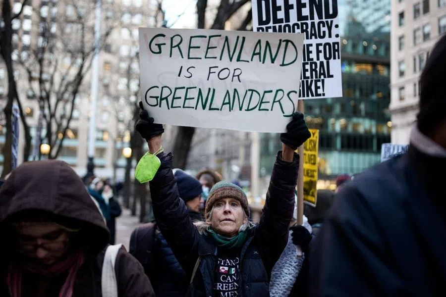 A demonstrator holds a "Greenland is for Greenlanders" sign during a protest against Immigration and Customs Enforcement (ICE) in New York, US, 20 January 2026. (Adam Gray/Bloomberg)