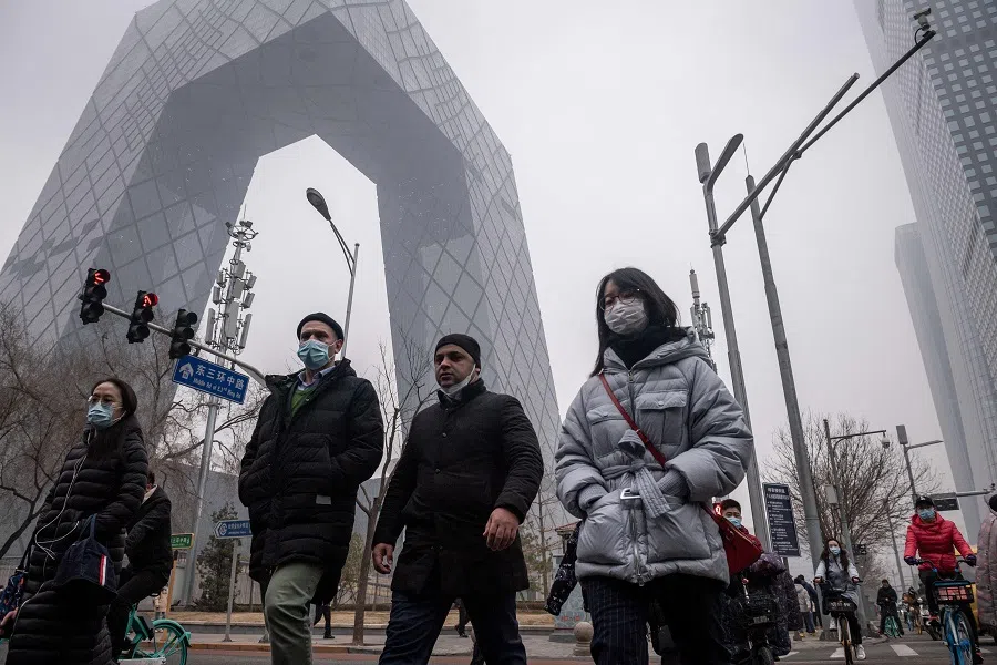 People commute during the morning rush hour in the financial district in Beijing, China, on 4 March 2021. (Nicolas Asfouri/AFP)