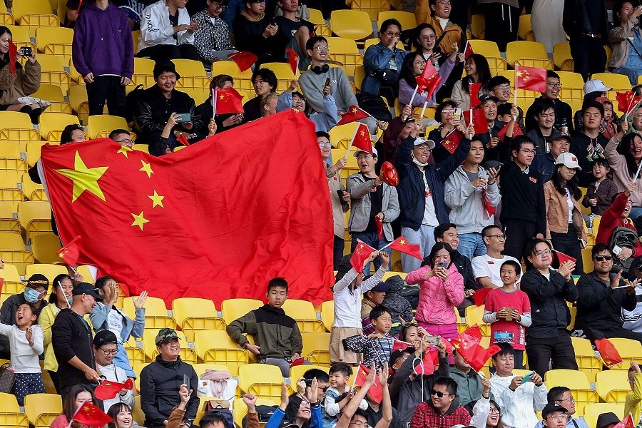 China fans celebrate their team's first goal in the stands during the friendly football match between New Zealand and China at Sky Stadium in Wellington, New Zealand, on 26 March 2023. (Marty Melville/AFP)