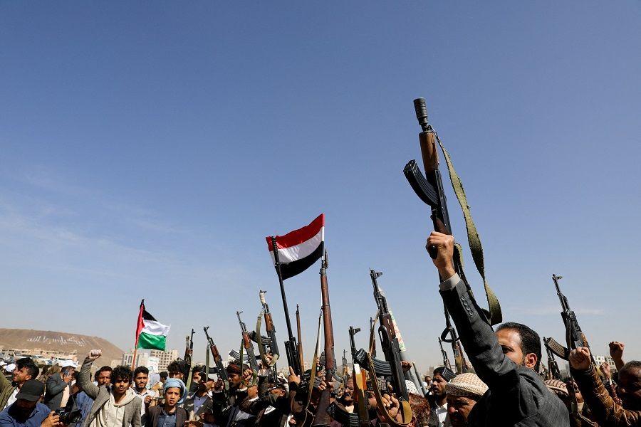 Houthi followers raise firearms during a parade in solidarity with the Palestinians in the Gaza Strip and to show support to Houthi strikes on ships in the Red Sea and the Gulf of Aden, in Sanaa, Yemen, on 29 January 2024. (Khaled Abdullah/Reuters)
