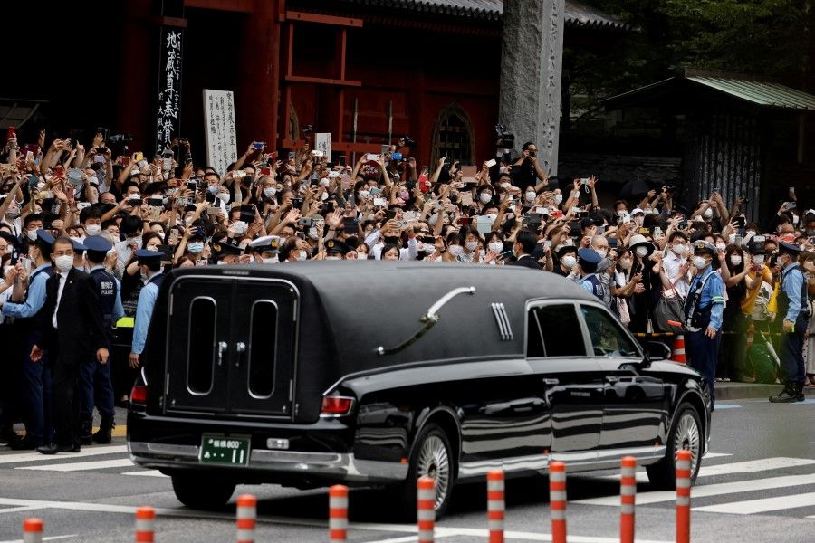 A vehicle carrying the body of the late former Japanese Prime Minister Shinzo Abe leaves after his funeral at Zojoji Temple in Tokyo, Japan, 12 July 2022. (Issei Kato/Reuters)
