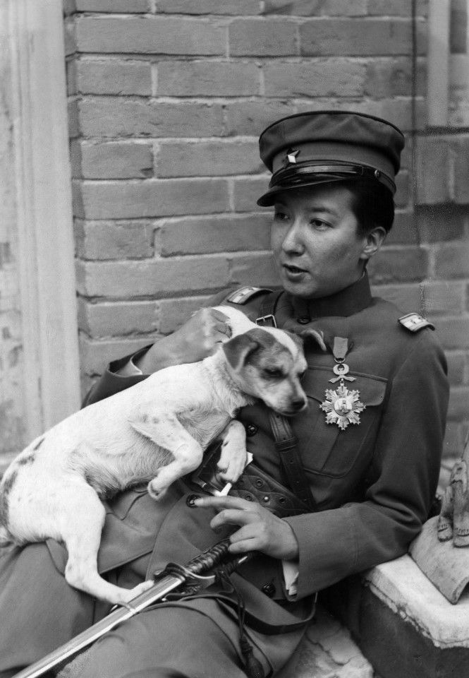 Nadine in uniform, with a dog.