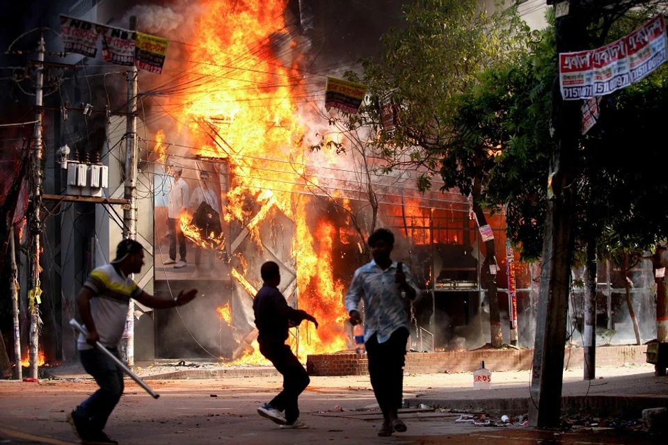 A garment store is reportedly set ablaze by a group of unidentified miscreants in Dhaka, Bangladesh, on 4 August 2024. (Abu Sufian Jewel/AFP)