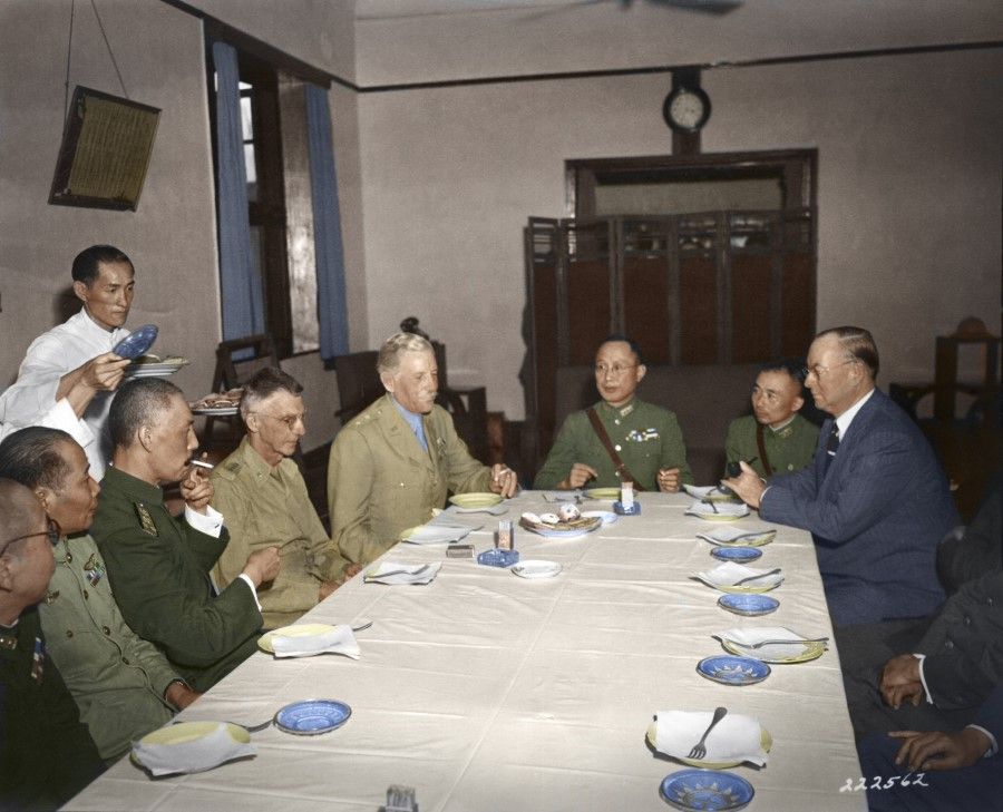 8 September 1944, Chungking - Top-ranking American and Chinese military officers are having lunch after a meeting at the Headquarters of the National Military Council in Chungking. From left, Gen. Chou Chih-jou (Zhou Zirou), commander of the Chinese Air Force; Admiral Yang Hsuan-cheng (Yang Xuancheng, smoking a cigarette), who was in charge of intelligence; Gen. Joseph W. Stilwell, chief of staff, US Army Forces, CBI Theatre; Maj. Gen. Patrick J. Hurley, military adviser on the War Production Board; Gen. Ho Ying-chin (He Yinqing), chief of staff; an interpreter; and Donald Nelson, chairman of the War Production Board.