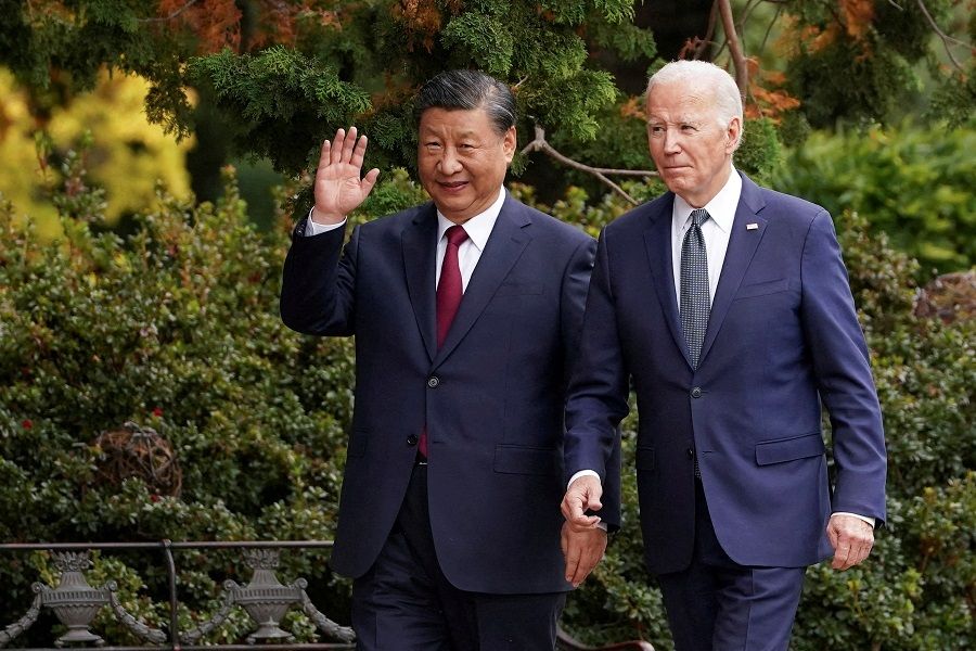 Chinese President Xi Jinping waves as he walks with US President Joe Biden at the Filoli estate on the sidelines of the Asia-Pacific Economic Cooperation (APEC) summit, in Woodside, California, US, on 15 November 2023. (Kevin Lamarque/Reuters)