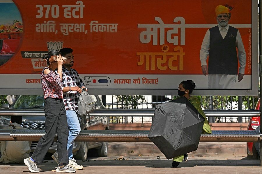People at a bus stop in New Delhi, India, on 25 April 2024. (Money Sharma/AFP)