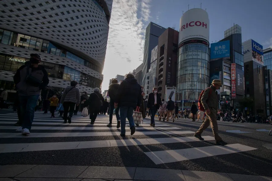 People cross a street in the Ginza shopping district in Tokyo on 6 December 2020. (Kazuhiro Nogi/AFP)