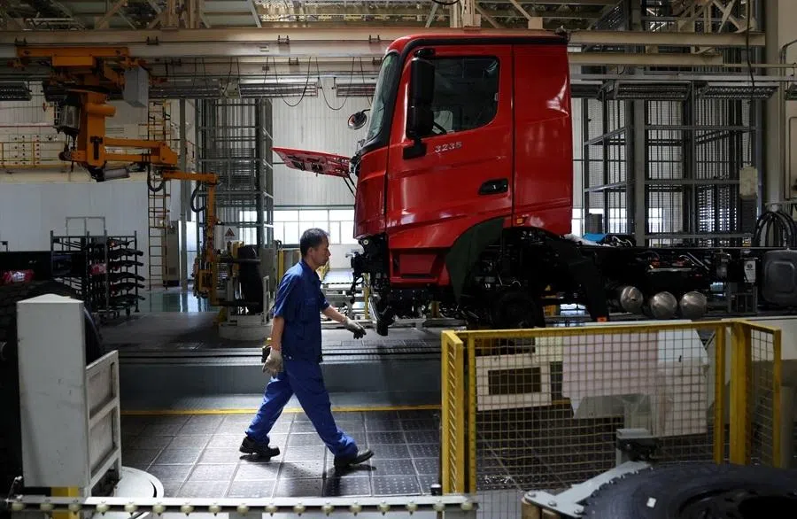 An employee walks at the truck assembly line at Beiben Trucks Group factory in Baotou, Inner Mongolia Autonomous Region, China, on 13 June 2026.