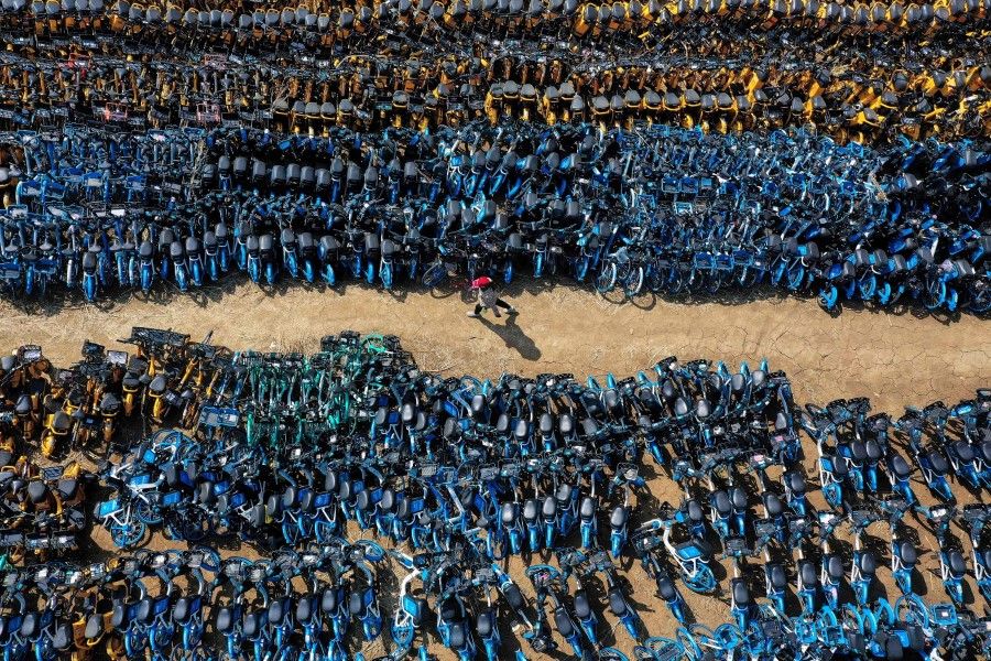 This aerial photo taken on 19 April 2021 shows abandoned public shared bicycles at a lot in Shenyang in China's northeastern Liaoning province. (STR/AFP)