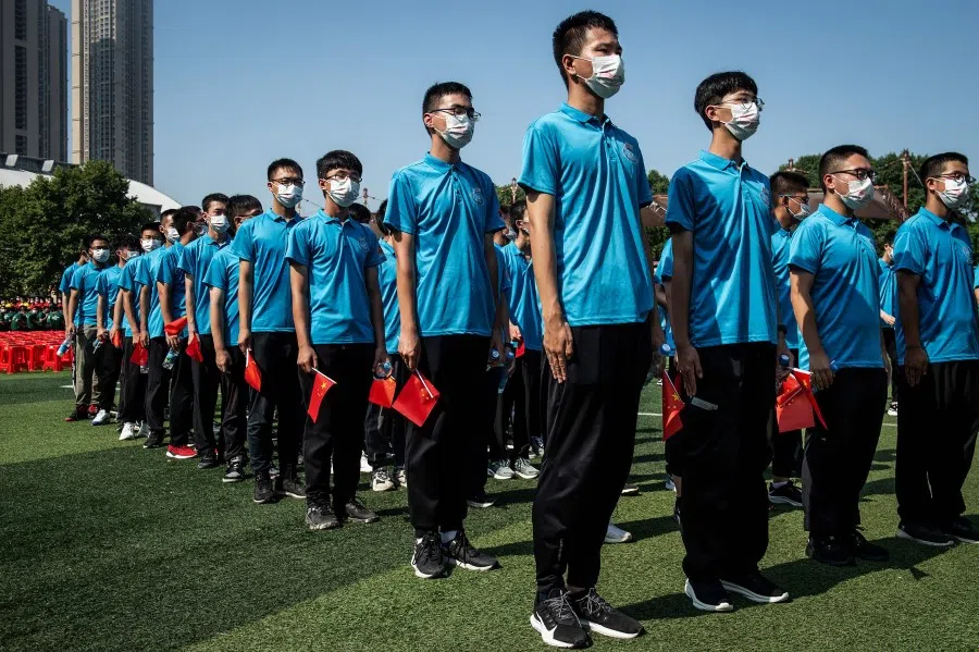 University students attend an opening ceremony of the new semester in Wuhan in China's central Hubei province on 10 September 2021. (STR/AFP)