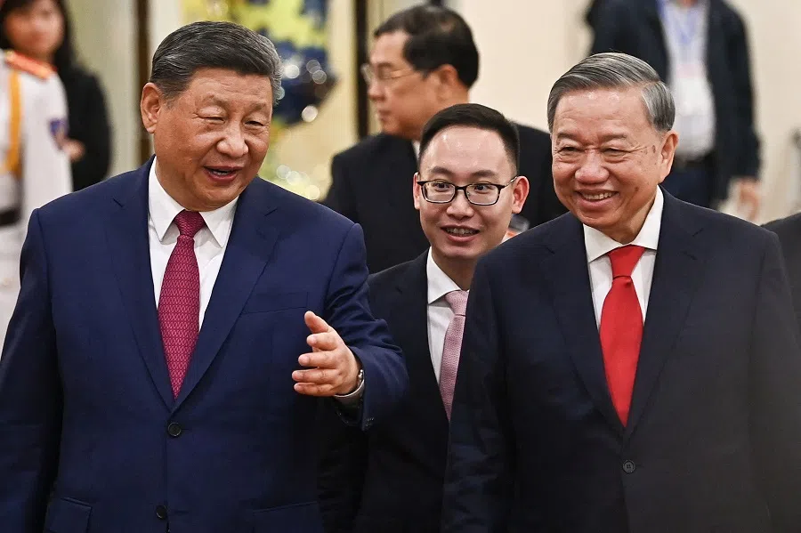 Vietnam’s Communist Party General Secretary To Lam and China’s President Xi Jinping leave after their meeting at the office of the Party Central Committee in Hanoi on 14 April 2025. (Nhac Nguyen/Pool via Reuters)