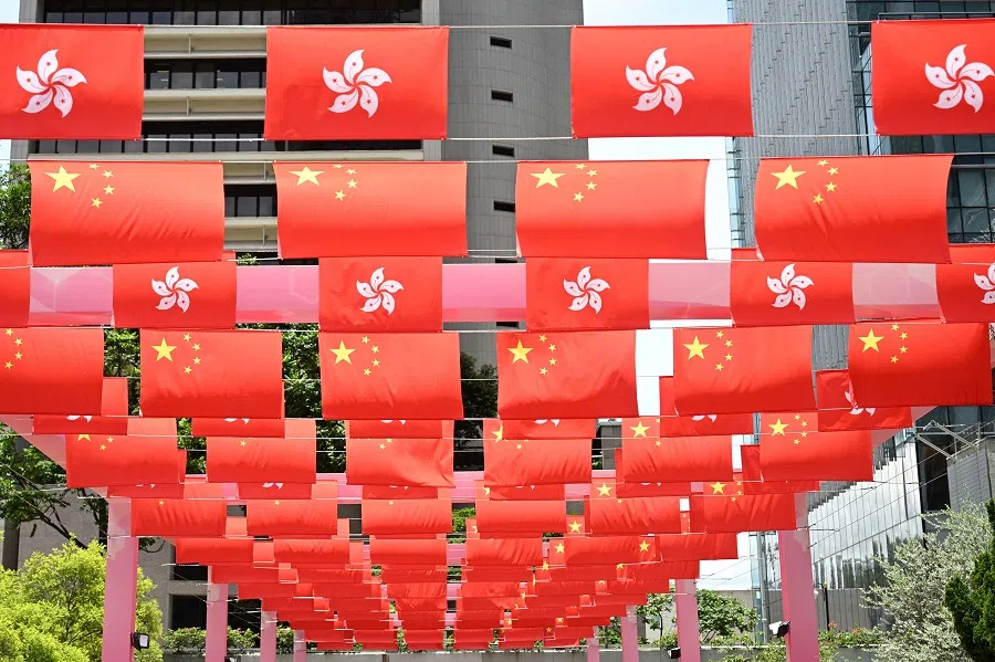 Hong Kong and China flags are displayed over a pathway ahead of the 28th anniversary of the handover of Hong Kong from Britain to China in Hong Kong on 24 June 2025. (Peter Parks/AFP)
